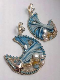 pair of blue and white earrings with pearls