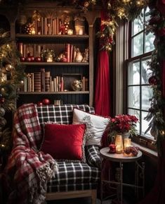 a living room decorated for christmas with red and green decorations on the windowsills