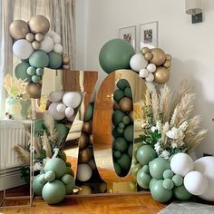 balloons and flowers are arranged in the shape of the number 10 on a mirror frame