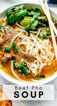 beef pho soup in a bowl with chopsticks and bread on the side