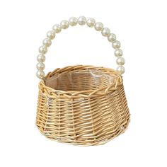 a wicker basket with pearls hanging from the handle, on a white background photo