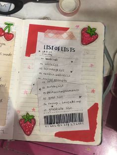 an open notebook with writing on it and some strawberries attached to the pages next to scissors