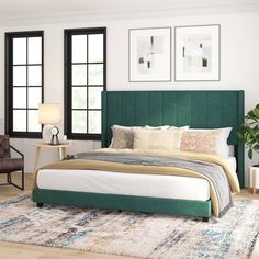 a bedroom with a green headboard and white bed in the center, two chairs on either side