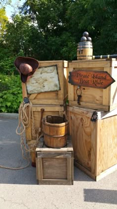 an old fashioned pirate island boat ride with wooden boxes and buckets on the ground