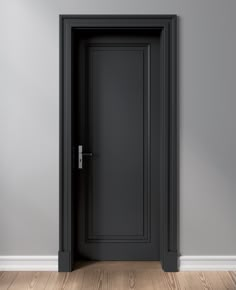 an empty room with a black door and wood flooring on one side, there is a gray wall and wooden floors on the other side