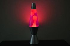 a black table with a red light on it and a lamp in the shape of a cone