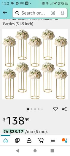 a bunch of white flowers sitting on top of a metal stand next to each other