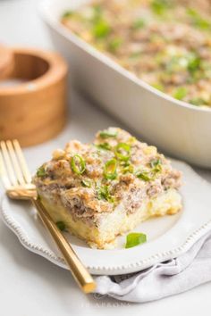 a white plate topped with food next to a casserole dish