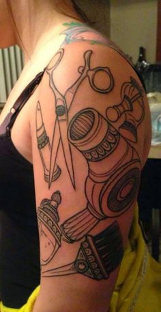 a woman with a tattoo on her arm has scissors and other things in the background