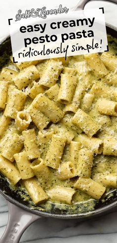 a skillet filled with pasta covered in pesto sauce and topped with a sign that says easy creamy pesto pasta ridiculously simple