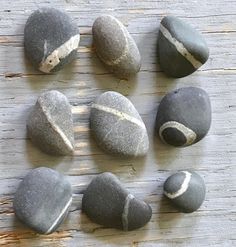 several rocks are arranged on a wooden surface