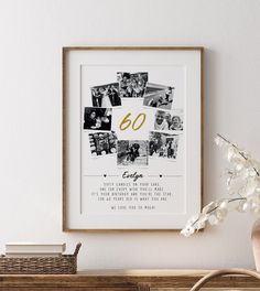 a white framed photo with the number 60 on it next to a vase and flowers