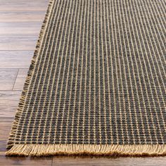 a close up of a rug on a wooden floor with wood floors and hard wood planks