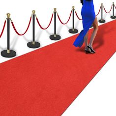 a woman is walking down the red carpet