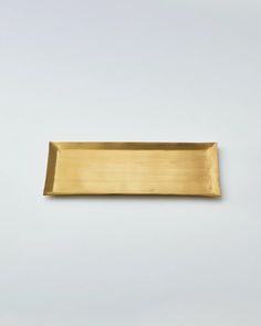 a brass rectangular tray on a white background