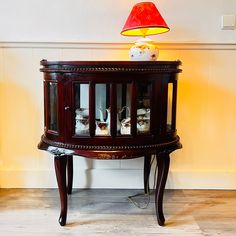 a table with three jars in it and a lamp on the side wall behind it