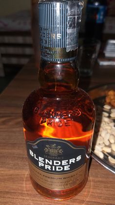 a bottle of liquor sitting on top of a wooden table