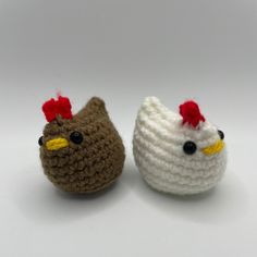 two crocheted chickens sitting next to each other