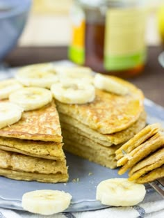 a stack of pancakes with sliced bananas on top