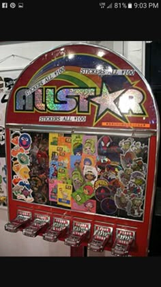 an old style pinball machine with lots of stickers on it