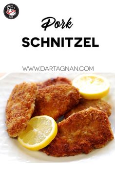 fried pork schnitzel with lemons on a white plate and the words pork schnitzl above it