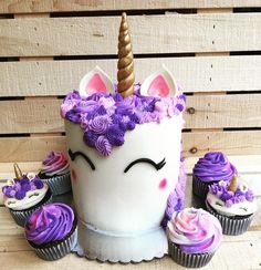 there is a cake with cupcakes in the shape of a unicorn