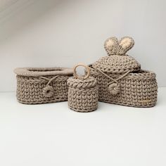 three woven baskets with lids and handles