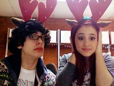 two people wearing reindeer antlers on their heads