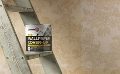 a wallpaper cover - up on a wooden ladder