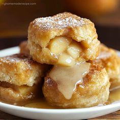 three pieces of apple pie sitting on top of a white plate covered in powdered sugar