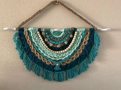 a wall hanging with beads and tassels