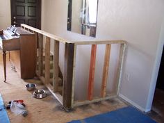 a room that is being remodeled with wood framing on the floor and walls, along with other items