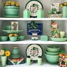 green dishes and plates on shelves in a room