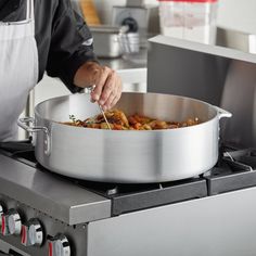 a person cooking food in a pot on the stove