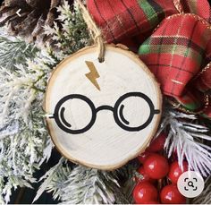 a wooden ornament with a lightning bolt drawn on it next to christmas decorations