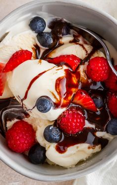 a bowl filled with ice cream and berries