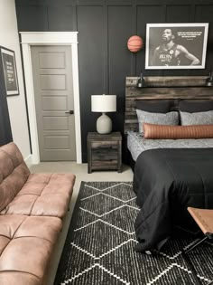 a bedroom with a couch, bed and basketball poster on the wall