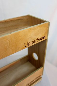 an open wooden box with the word upper slide on it