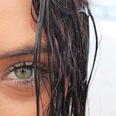 a close up of a person's face with wet hair on top of their head