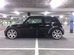 a black car parked in a parking garage