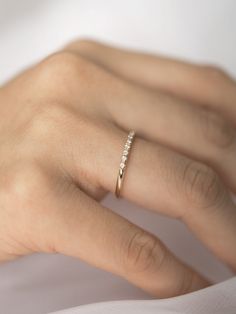 a woman's hand with a diamond ring on it