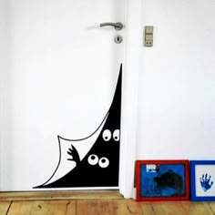 a door with a black cat on it and hand prints in front of the door