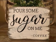 a wooden sign that says pour some sugar on me coffee next to a potted plant