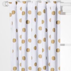 a white curtain with gold polka dots on it