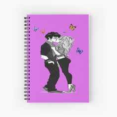 a couple kissing in front of butterflies on a purple background spiral notebook with pink cover