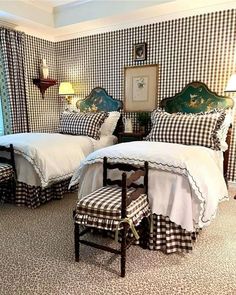 two beds in a room with black and white checkered walls