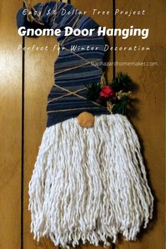 a gnome door hanger made out of yarn on a wooden floor with text overlay that says gnome door hanging