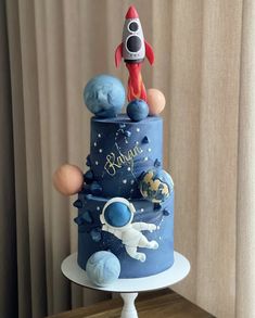 a blue cake with an astronaut on top