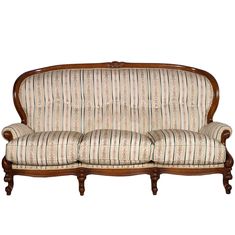 an old fashioned couch with striped upholstered fabric and wood frame, on white background