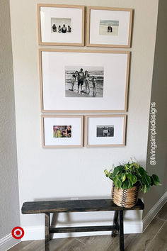 a wooden bench sitting in front of a wall with pictures hanging on it's sides